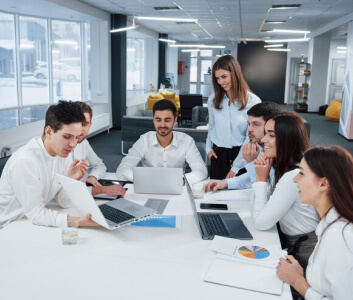 Colleagues collaborating at desk